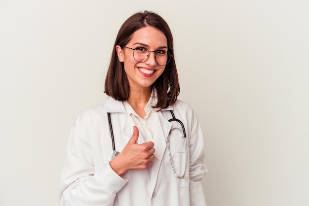 Young doctor caucasian woman isolated on white background smiling and raising thumb up