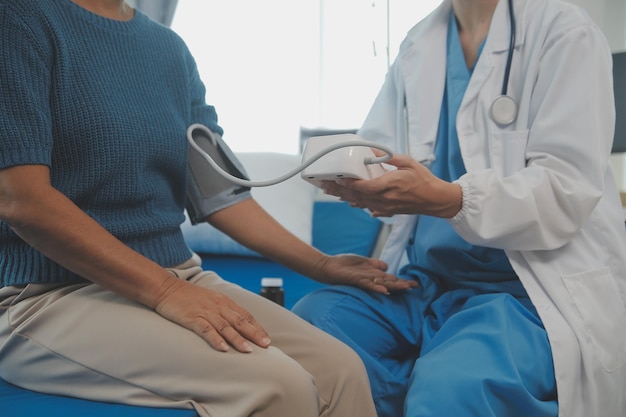 Young doctor is using a stethoscope listen to the heartbeat of the patient Shot of a female doctor giving a male patient a check up