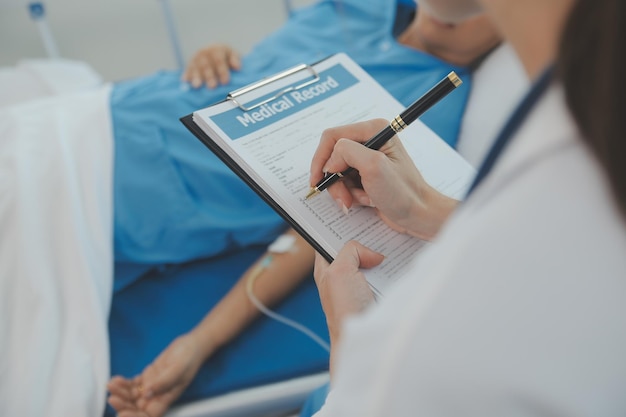 Young doctor is using a stethoscope listen to the heartbeat of the patient Shot of a female doctor giving a male patient a check up