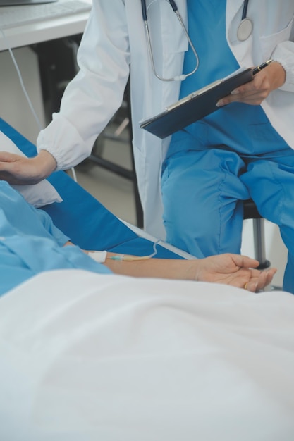 Young doctor is using a stethoscope listen to the heartbeat of the patient Shot of a female doctor giving a male patient a check up