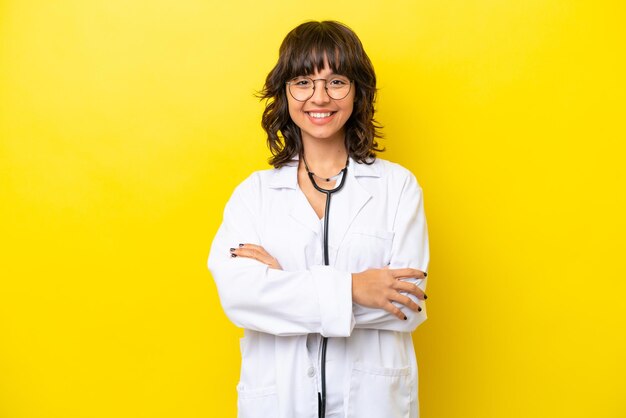 Young doctor latin woman isolated on yellow background