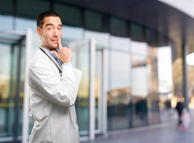 Young doctor pointing with his hand