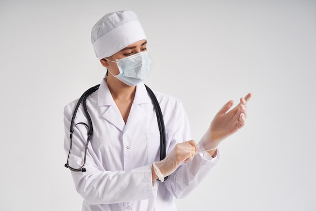 Young doctor putting on surgical gloves