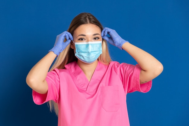 Young doctor wearing a mask face and a pink uniform