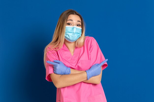 Young doctor wearing a mask face and a pink uniform