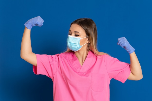 Young doctor wearing a mask face and a pink uniform