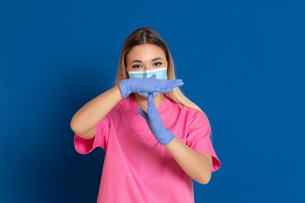 Young doctor wearing a mask face and a pink uniform