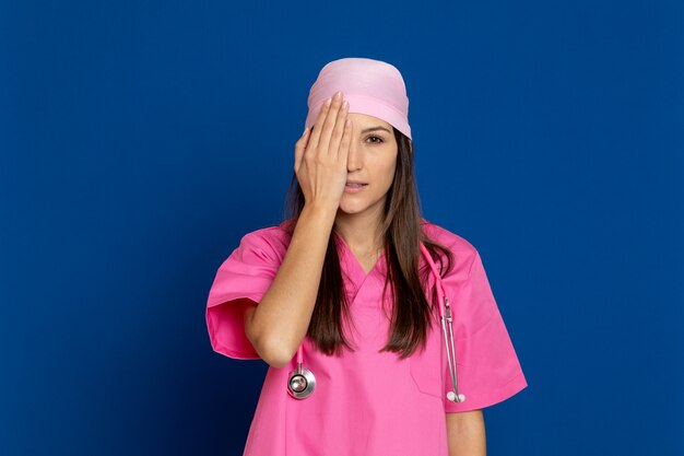 Young doctor with a pink uniform