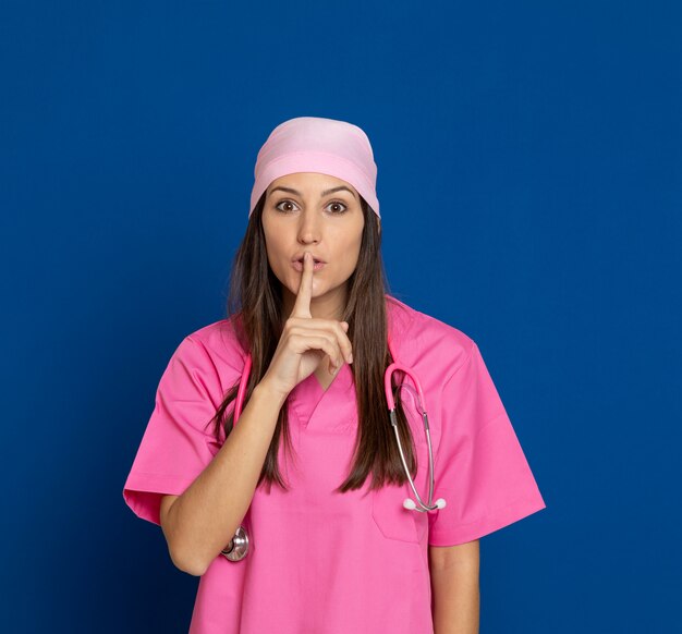 Young doctor with a pink uniform