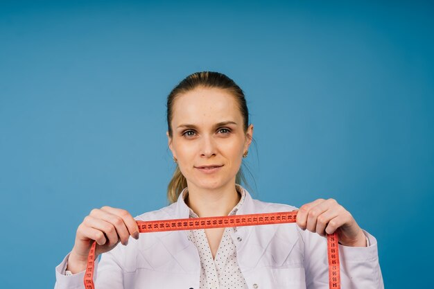 Young doctor woman in white lab coat, studio shot