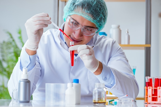 Young doctor working on blood test in lab hospital