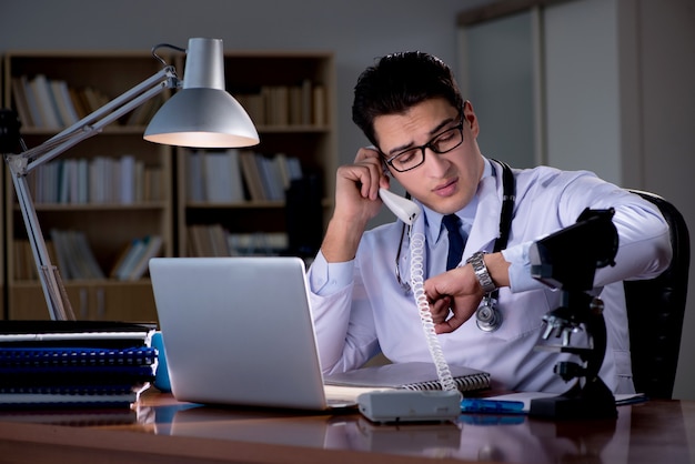 Young doctor working late in the office