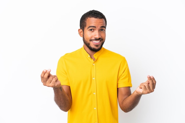 Young Ecuadorian man isolated on white background making money gesture