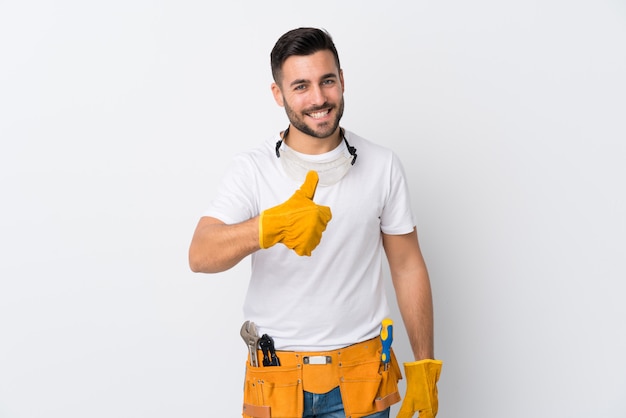 Young electrician man over isolated wall