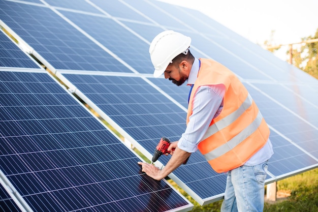 The young electrician works at a solar station