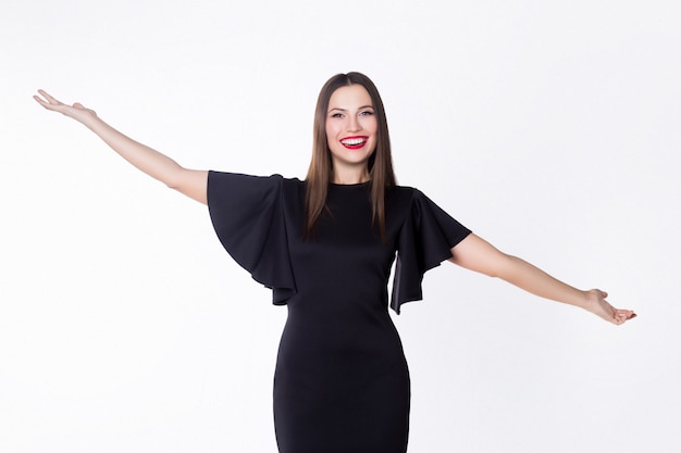 Young elegant girl dressed in a black dress in the studio on a white background. Business concept