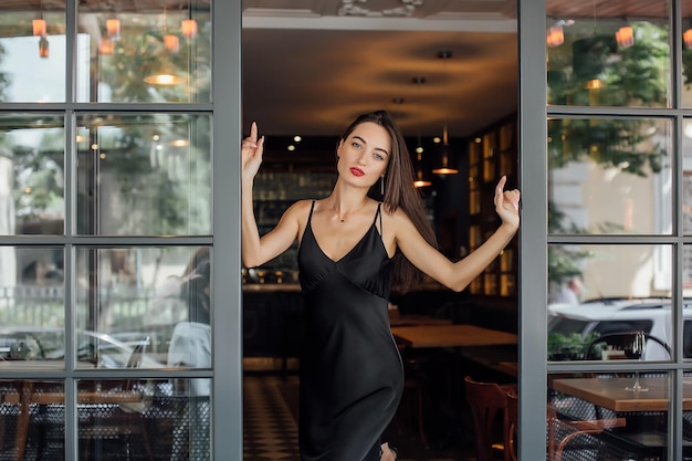 Young elegant woman hold glass of red wine indoor shot selective focus