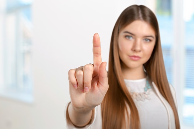 Young elegant woman pointing 