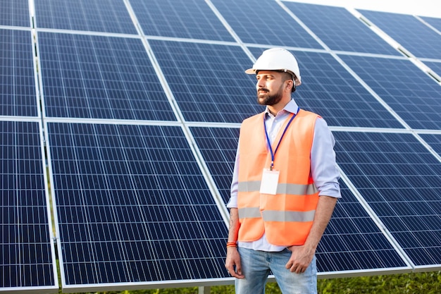 The young engineer stands at a solar station