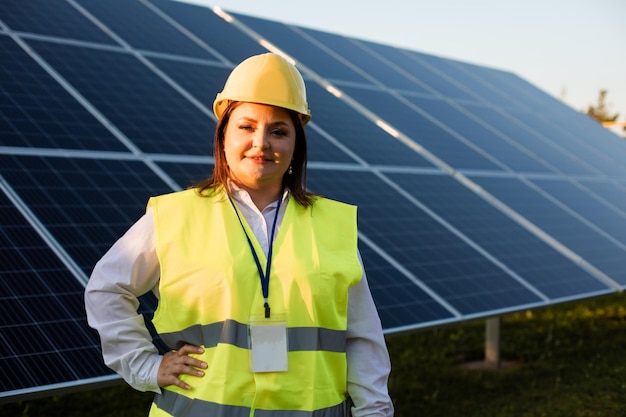 The young engineer stands at a solar station