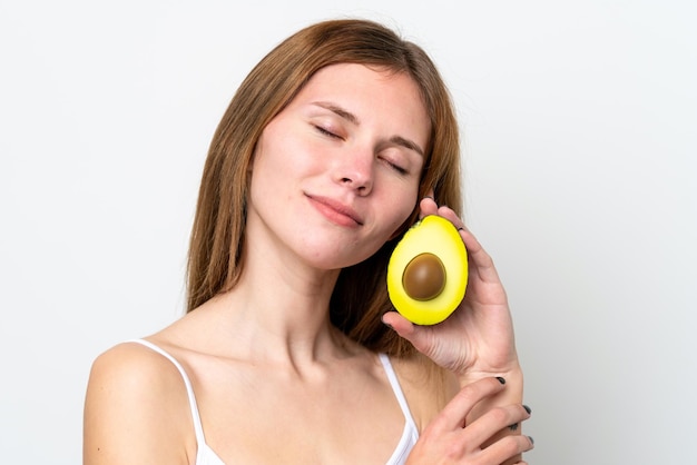 Young English woman holding an avocado Close up portrait