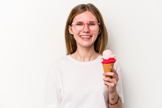 Young English woman holding an ice cream isolated on white background happy smiling and cheerful