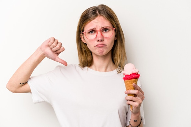 Young English woman holding an ice cream isolated on white background showing a dislike gesture thumbs down Disagreement concept