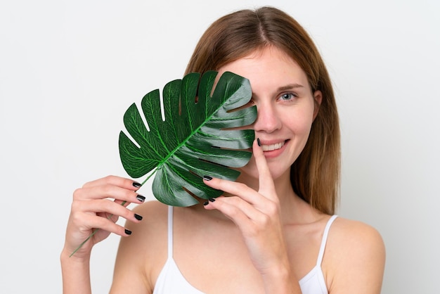 Young English woman holding a palm leaf Close up portrait