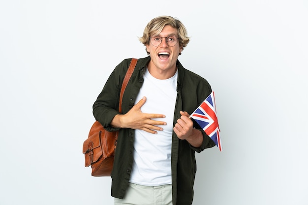 Young English woman holding an United Kingdom flag smiling a lot