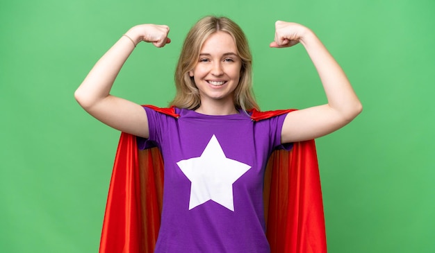 Young English woman over isolated background in superhero costume and doing strong gesture