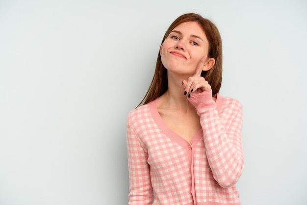 Young English woman isolated on blue background showing number one with finger