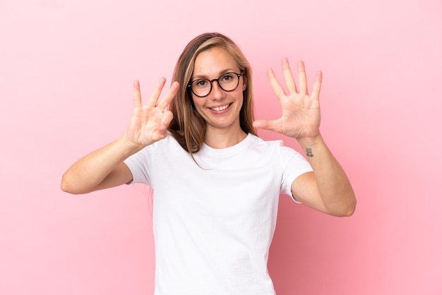 Young English woman isolated on pink background counting eight with fingers