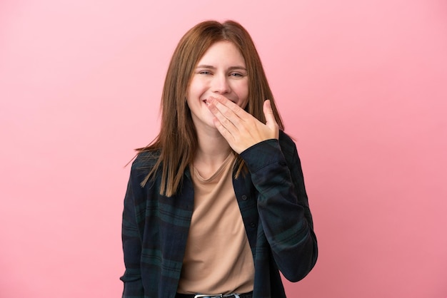 Young English woman isolated on pink background happy and smiling covering mouth with hand