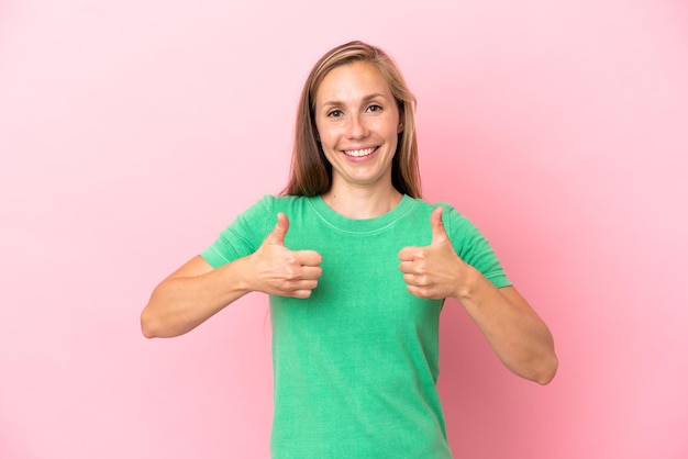 Photo young english woman isolated on pink background with thumbs up gesture and smiling