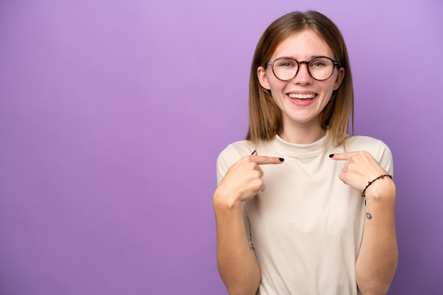 Young English woman isolated on purple background with surprise facial expression