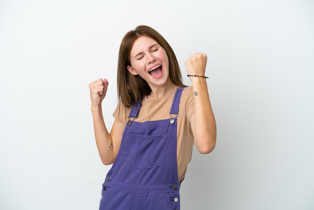 Young English woman isolated on white background celebrating a victory