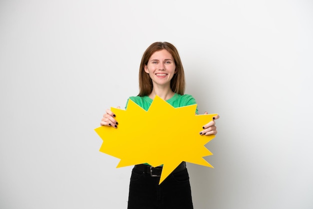 Young English woman isolated on white background holding an empty speech bubble