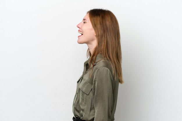 Young English woman isolated on white background laughing in lateral position