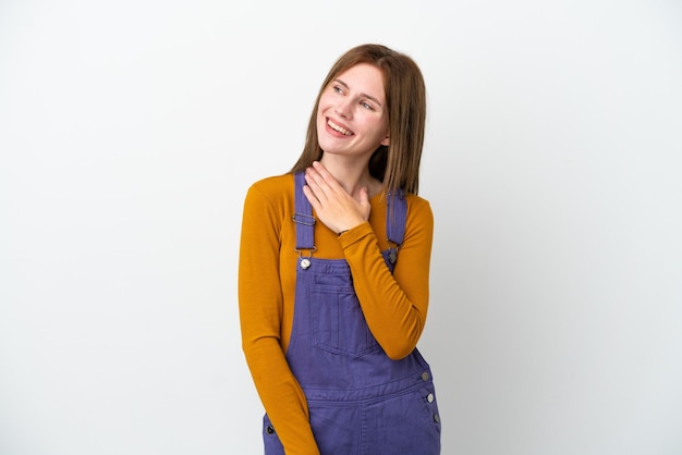 Young English woman isolated on white background looking up while smiling