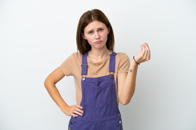 Young English woman isolated on white background making Italian gesture