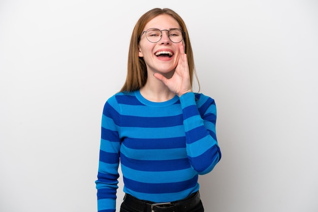 Young English woman isolated on white background shouting with mouth wide open