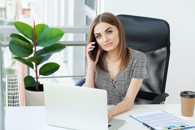 Young entrepreneur woman working with laptop sitting in the office