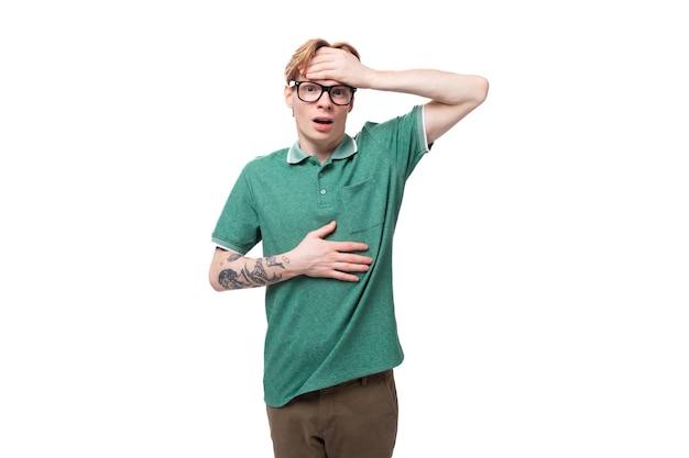 Young european guy with red hair is shocked and puzzled on a white background with copy space