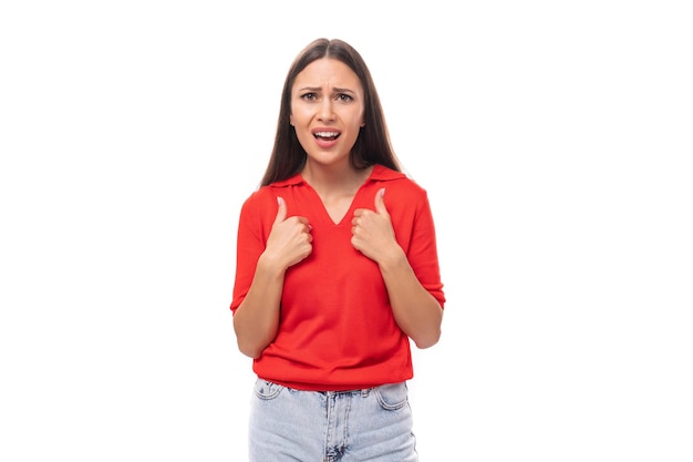 Young excited brunette lady dressed in a red tshirt on a white background