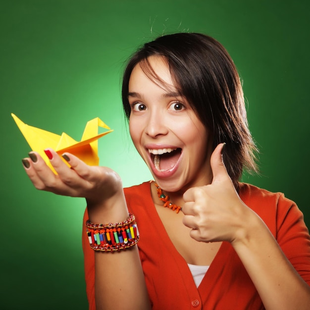 Young expression woman with paper bird