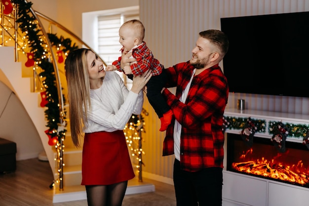 Young family celebrating Christmas at home. Happy young family enjoying their holiday time together.