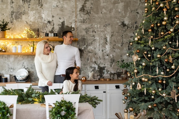 Young family celebrating Christmas at home. Happy young family enjoying their holiday time together.