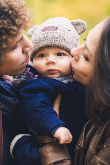 Young family hugging in autumn in park