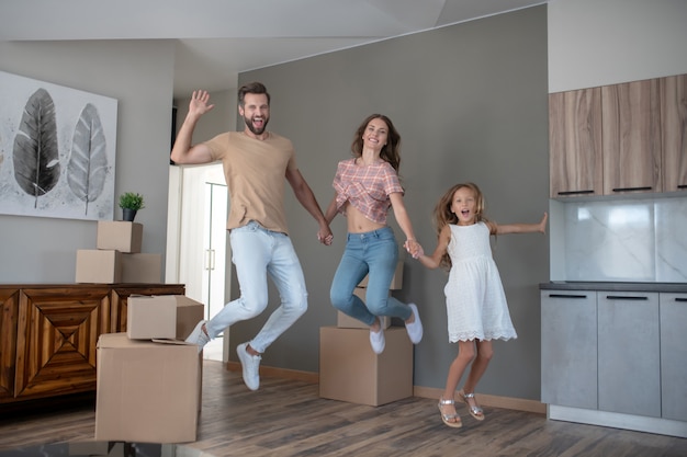 Young family jumping and looking excited