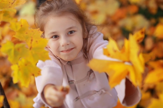 Young family on a walk in the autumn park on a sunny day Happiness to be together